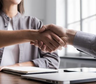 Young business people shaking hands in the office. Business etiquette, congratulation, meeting, job interview, new business, startup, employee concepts